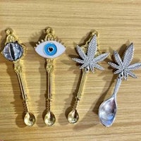 three spoons with marijuana leaves on them