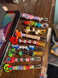 a group of beads on a table next to a laptop