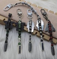 a group of metal keychains on a furry surface