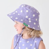 a little girl wearing a purple bucket hat